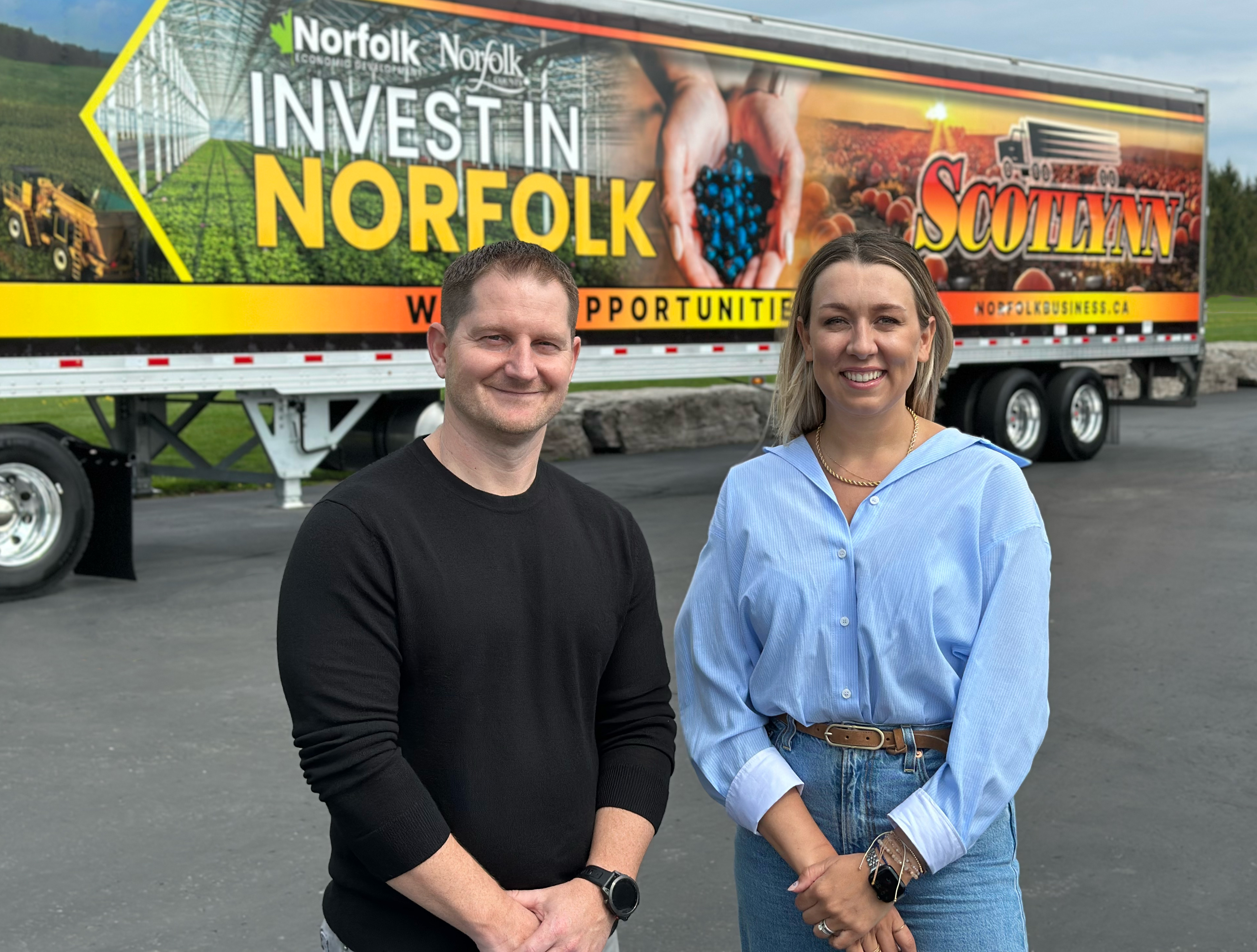 Brad Mitchell and Mayor Amy Martin standing in front of a Scotlynn trailer featuring agriculture imagery and slogan “Where Opportunities Thrive.”